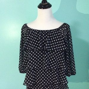 Black and white polka dotted blouse.